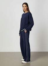 Vector Sportswear Lounge Strides wide-leg pants with elastic waist and piping detail for modern style.