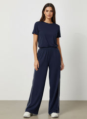 Vector Sportswear Lounge Strides wide-leg pants with elastic waist and piping detail for modern style.