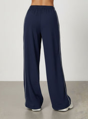 Vector Sportswear Lounge Strides wide-leg pants with elastic waist and piping detail for modern style.