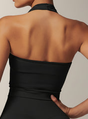 Vector Sportswear black halter crop top featuring open-back design, soft stretch fabric, and sculpting athletic fit.