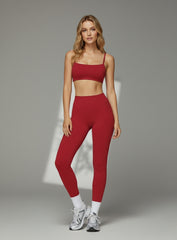 Model wearing CloudSense Brushed Sports Bra in bright red with seamless fit and soft square neckline | Vectorsportswear