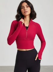 women’s half-zip yoga top with thumbholes, slim fit long sleeves, cropped length.