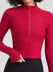 Close-up of red ribbed half-zip mock-neck yoga top, breathable quick-dry fabric.