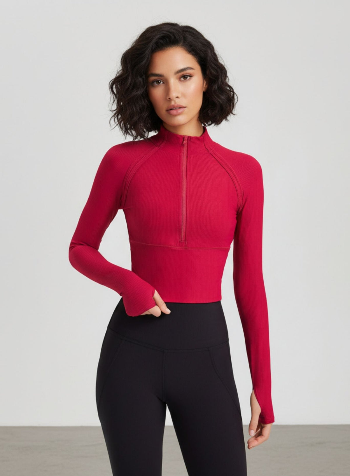 women’s half-zip yoga top with thumbholes, slim fit long sleeves, cropped length.