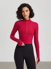 women’s half-zip yoga top with thumbholes, slim fit long sleeves, cropped length.