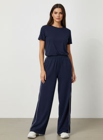 Vector Sportswear Lounge Strides wide-leg pants with elastic waist and piping detail for modern style.