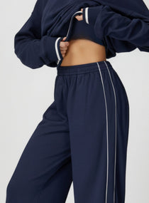 Vector Sportswear Lounge Strides wide-leg pants with elastic waist and piping detail for modern style.