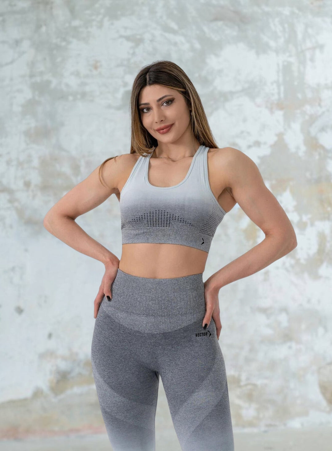 Premium Photo  A woman is wearing a gray sports bra and leggings