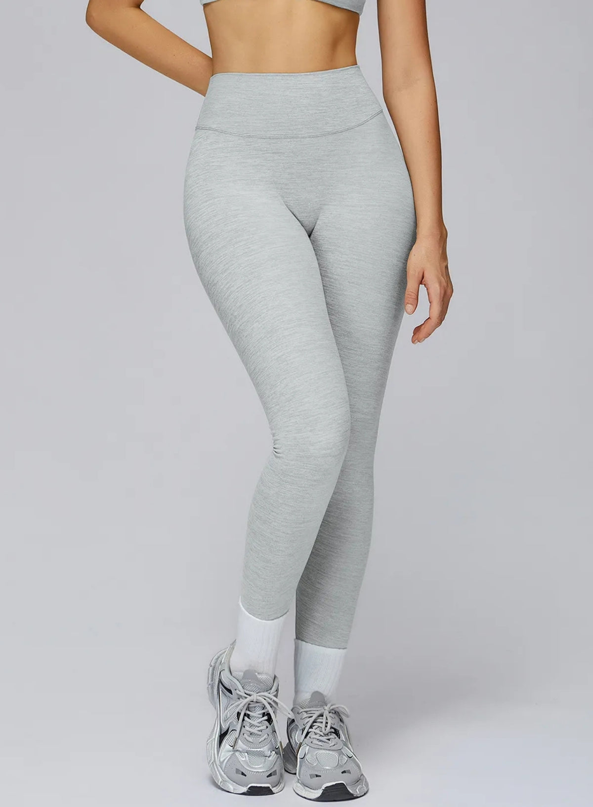 Model wearing CloudSense brushed seamless high-waist leggings with peach-lift sculpt design | Vector Sportswear