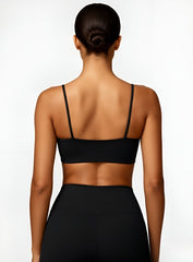 Rear view of model wearing black CloudSense Seamless Sling Bra — seamless open-back design with thin sling straps and sculpting performance fabric. | Vectorsportswear