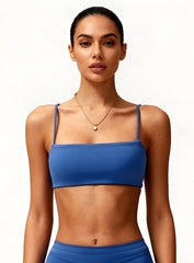 Woman wearing the CloudSense Seamless Sling Bra in black — open-back seamless sports bra with thin sling straps, sculpting fit, and smooth activewear fabric. | Vectorsportswear