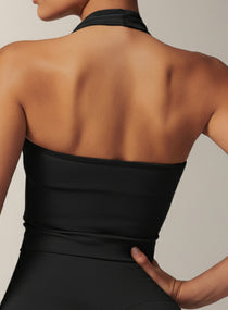 Vector Sportswear black halter crop top featuring open-back design, soft stretch fabric, and sculpting athletic fit.